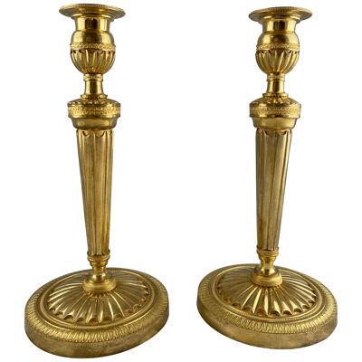 A pair of french gilt bronze candlesticks, late 18th c