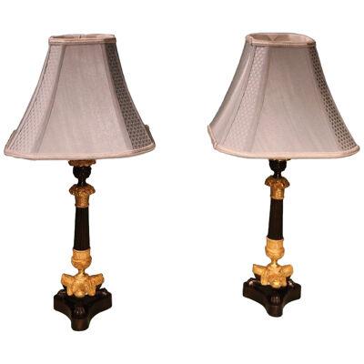 A pair of Regency period bronze / ormolu triform candlesticks converted to lamps