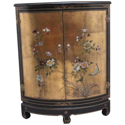 A decorative mid 20th Century painted and lacquered corner cabinet