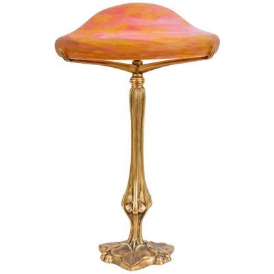 A Louis Majorelle and Daum Nancy Gilt Bronze and Pink Glass Table Lamp
