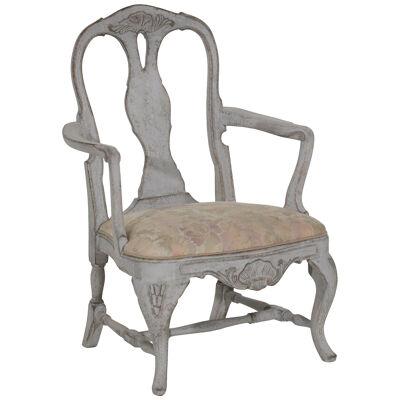 This 19th Century Swedish armchair displays exquisite carvings.
