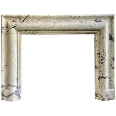 A Large Breche Violette Marble Bolection Fireplace 