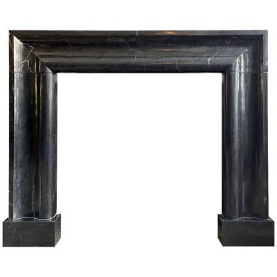 A Very Large Black Marble Bolection Fireplace Mantel