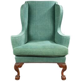 A George II carved walnut wing armchair