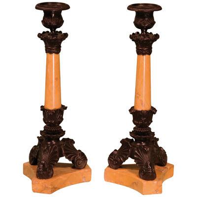 A pair of 19th century Regency bronze and Sienna marble candlesticks