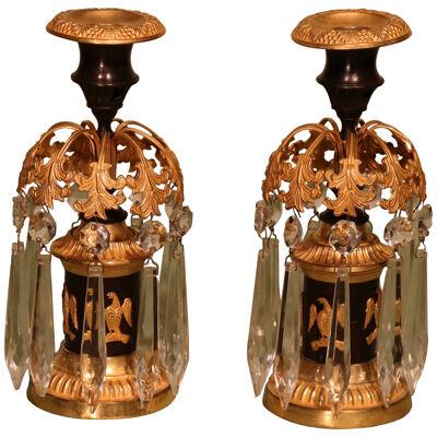 A pair of early 19th century bronze and ormolu lustre candlesticks