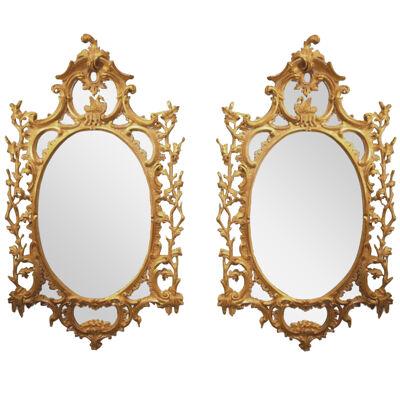 An important Pair of mid 18th Century oval giltwood Mirrors.