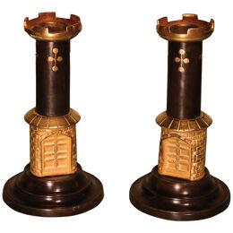 An unusual pair of mid 19th century bronze and ormolu candlesticks