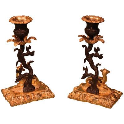 A Pair of 19th century bronze and ormolu stag and deer candlesticks