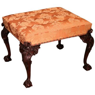 A mid 19th century carved mahogany stool in the Chippendale style