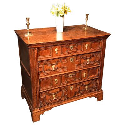 A Jacobean Oak Straight Fronted Chest of Four Full Width Drawers